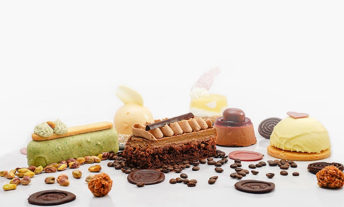 A selection of Hannes cakes and gelato arranged on a white ground